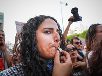 A young female demonstrator blows a whistle during a demonstration organized by the Tunisian Network for Rights and Freedoms in Tunis, Tunis...