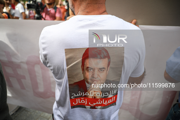 A demonstrator wearing a T-shirt with a photo of jailed presidential candidate Ayachi Zammel attends a demonstration organized by the Tunisi...