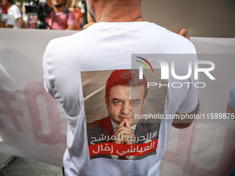 A demonstrator wearing a T-shirt with a photo of jailed presidential candidate Ayachi Zammel attends a demonstration organized by the Tunisi...