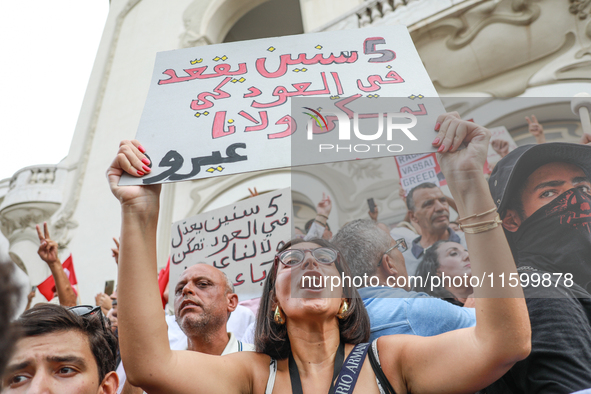 A female demonstrator shouts slogans as she raises a placard that reads in Arabic, ''He does nothing for five years,'' during a demonstratio...