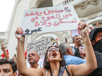 A female demonstrator shouts slogans as she raises a placard that reads in Arabic, ''He does nothing for five years,'' during a demonstratio...