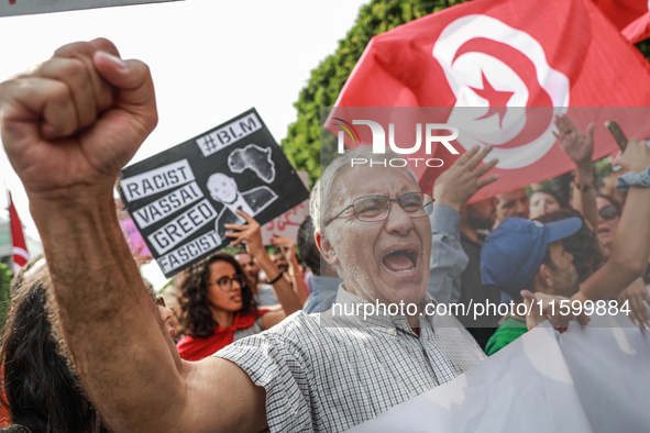 A demonstrator raises his fist as he shouts slogans during a demonstration organized by the Tunisian Network for Rights and Freedoms in Tuni...