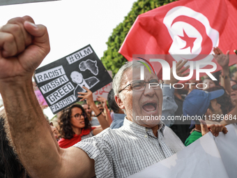 A demonstrator raises his fist as he shouts slogans during a demonstration organized by the Tunisian Network for Rights and Freedoms in Tuni...