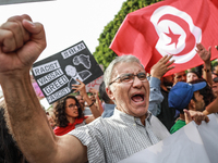 A demonstrator raises his fist as he shouts slogans during a demonstration organized by the Tunisian Network for Rights and Freedoms in Tuni...