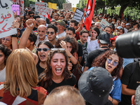 Young female demonstrators shout slogans during a demonstration organized by the Tunisian Network for Rights and Freedoms in Tunis, Tunisia,...