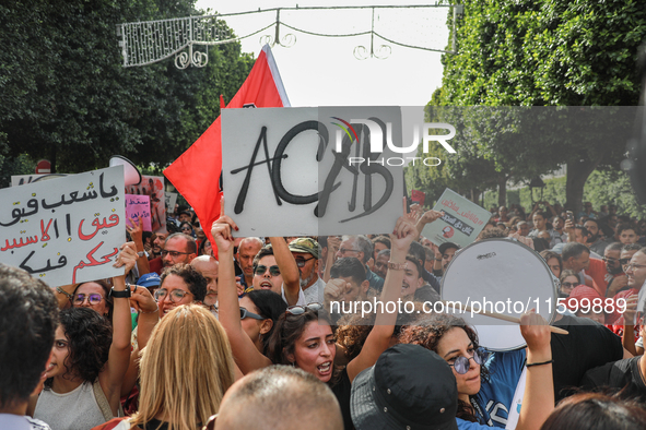 A young woman raises a placard that reads ''ACAB'' during a demonstration organized by the Tunisian Network for Rights and Freedoms in Tunis...