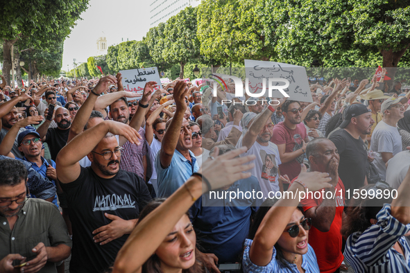 Demonstrators wave their arms as they shout, ''DEGAGE'' (get out), during a demonstration organized by the Tunisian Network for Rights and F...