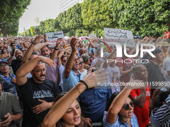 Demonstrators wave their arms as they shout, ''DEGAGE'' (get out), during a demonstration organized by the Tunisian Network for Rights and F...