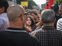 A young female demonstrator raises her fist as she shouts slogans during a demonstration organized by the Tunisian Network for Rights and Fr...