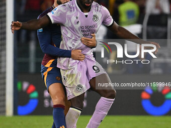 Mario Hermoso of A.S. Roma and Keinan Davis of Udinese Calcio are in action during the 5th day of the Serie A Championship between A.S. Roma...