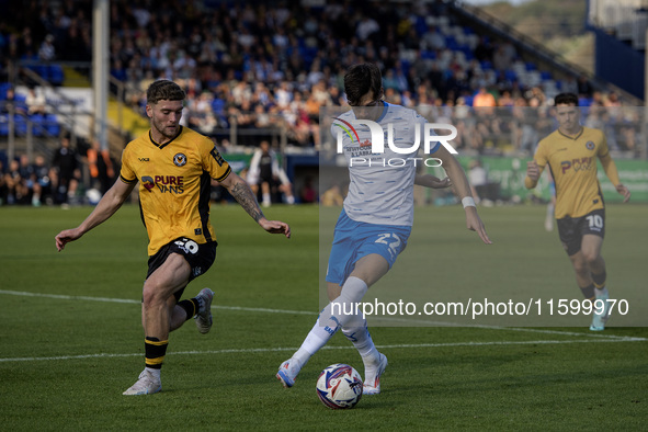 Barrow's Chris Popov is in action with Newport County's Cameron Evans during the Sky Bet League 2 match between Barrow and Newport County at...