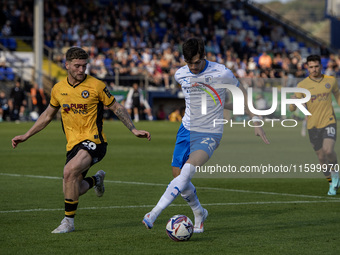 Barrow's Chris Popov is in action with Newport County's Cameron Evans during the Sky Bet League 2 match between Barrow and Newport County at...