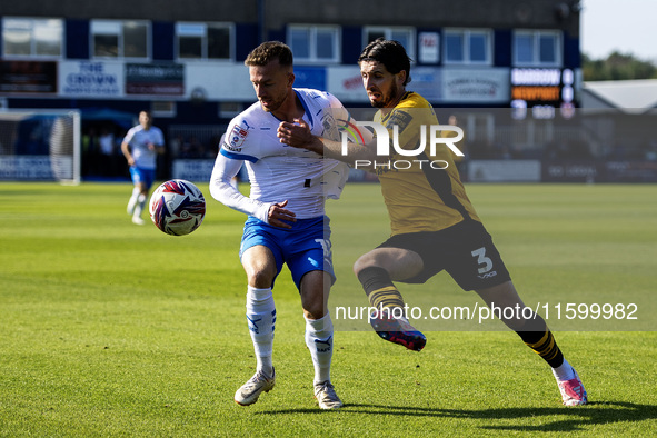 Elliot Newby of Barrow battles with Anthony Glennon of Newport County during the Sky Bet League 2 match between Barrow and Newport County at...