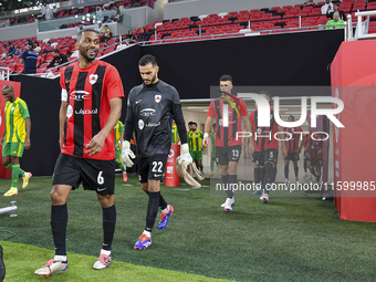 Al Rayyan SC and Al Wakrah SC players walk onto the pitch before the Ooredoo Qatar Stars League 24/25 match between Al Rayyan SC and Al Wakr...