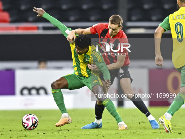 Jacinto Dala (L) of Al Wakrah SC battles for the ball with Gabriel Julien De Sart of Al Rayyan SC during the Ooredoo Qatar Stars League 24/2...