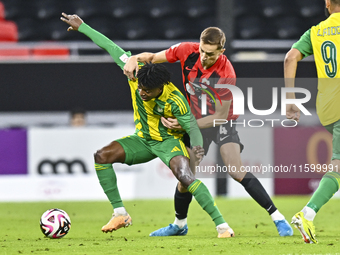 Jacinto Dala (L) of Al Wakrah SC battles for the ball with Gabriel Julien De Sart of Al Rayyan SC during the Ooredoo Qatar Stars League 24/2...