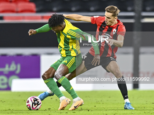 Jacinto Dala (L) of Al Wakrah SC battles for the ball with Gabriel Julien De Sart of Al Rayyan SC during the Ooredoo Qatar Stars League 24/2...