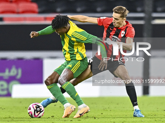 Jacinto Dala (L) of Al Wakrah SC battles for the ball with Gabriel Julien De Sart of Al Rayyan SC during the Ooredoo Qatar Stars League 24/2...