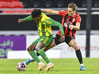 Jacinto Dala (L) of Al Wakrah SC battles for the ball with Gabriel Julien De Sart of Al Rayyan SC during the Ooredoo Qatar Stars League 24/2...