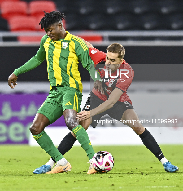 Jacinto Dala (L) of Al Wakrah SC battles for the ball with Gabriel Julien De Sart of Al Rayyan SC during the Ooredoo Qatar Stars League 24/2...