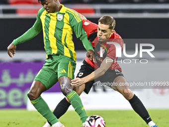 Jacinto Dala (L) of Al Wakrah SC battles for the ball with Gabriel Julien De Sart of Al Rayyan SC during the Ooredoo Qatar Stars League 24/2...