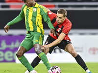 Jacinto Dala (L) of Al Wakrah SC battles for the ball with Gabriel Julien De Sart of Al Rayyan SC during the Ooredoo Qatar Stars League 24/2...