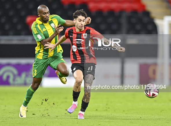 Abdelkarim Hassan of Al Wakrah SC battles for the ball with Gabriel Pereira of Al Rayyan SC during the Ooredoo Qatar Stars League 24/25 matc...