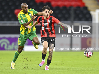 Abdelkarim Hassan of Al Wakrah SC battles for the ball with Gabriel Pereira of Al Rayyan SC during the Ooredoo Qatar Stars League 24/25 matc...