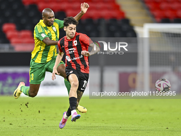 Abdelkarim Hassan of Al Wakrah SC battles for the ball with Gabriel Pereira of Al Rayyan SC during the Ooredoo Qatar Stars League 24/25 matc...