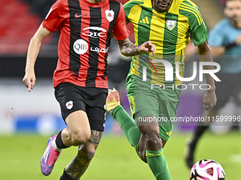 Abdelkarim Hassan (R) of Al Wakrah SC battles for the ball with Gabriel Pereira of Al Rayyan SC during the Ooredoo Qatar Stars League 24/25...