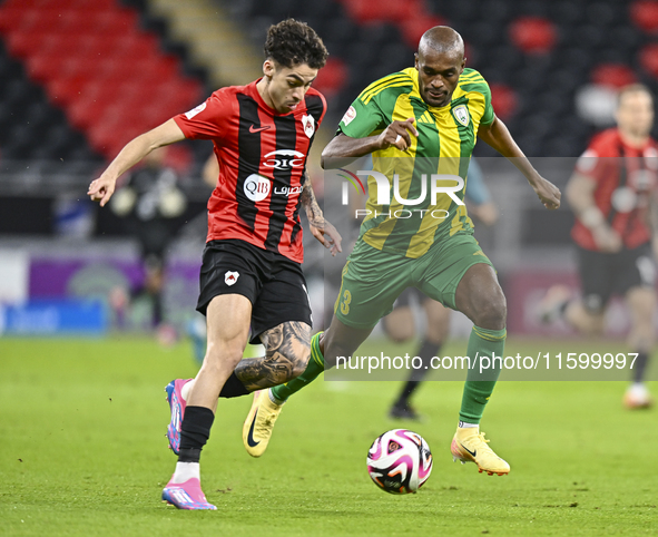 Abdelkarim Hassan (R) of Al Wakrah SC battles for the ball with Gabriel Pereira of Al Rayyan SC during the Ooredoo Qatar Stars League 24/25...