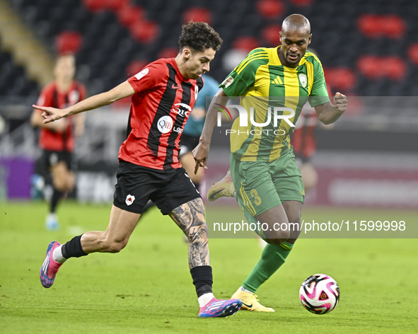 Abdelkarim Hassan (R) of Al Wakrah SC battles for the ball with Gabriel Pereira of Al Rayyan SC during the Ooredoo Qatar Stars League 24/25...