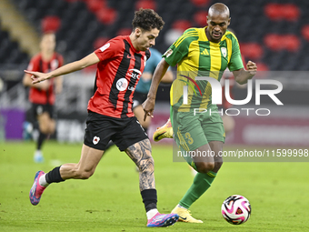 Abdelkarim Hassan (R) of Al Wakrah SC battles for the ball with Gabriel Pereira of Al Rayyan SC during the Ooredoo Qatar Stars League 24/25...