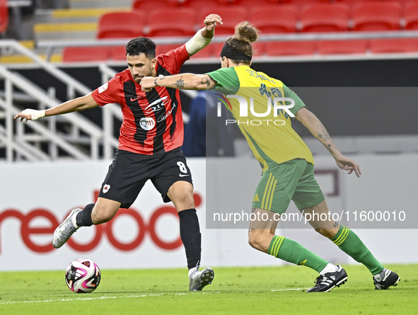 Alexander Scholz (R) of Al Wakrah SC battles for the ball with Mahmoud Hassan of Al Rayyan SC during the Ooredoo Qatar Stars League 24/25 ma...