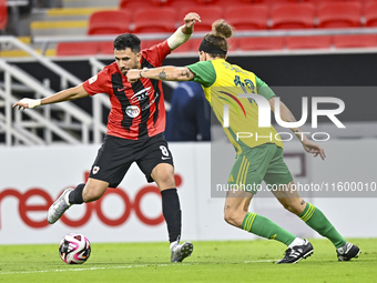 Alexander Scholz (R) of Al Wakrah SC battles for the ball with Mahmoud Hassan of Al Rayyan SC during the Ooredoo Qatar Stars League 24/25 ma...