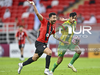 Nabil Irfan (R) of Al Wakrah SC battles for the ball with Mahmoud Hassan (L) of Al Rayyan SC during the Ooredoo Qatar Stars League 24/25 mat...