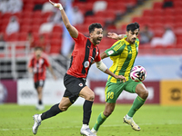 Nabil Irfan (R) of Al Wakrah SC battles for the ball with Mahmoud Hassan (L) of Al Rayyan SC during the Ooredoo Qatar Stars League 24/25 mat...