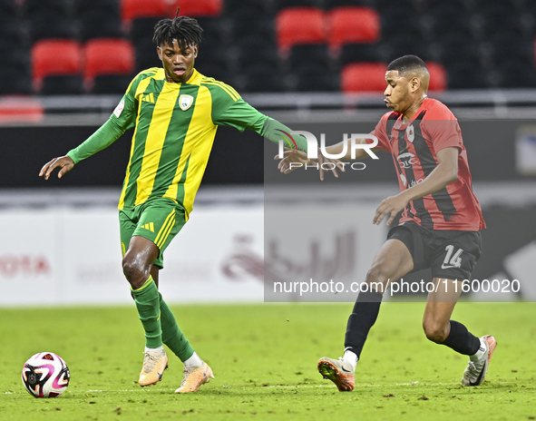 Jacinto Dala (L) of Al Wakrah SC battles for the ball with Andre Adel Bader Al-Ahmad (R) of Al Rayyan SC during the Ooredoo Qatar Stars Leag...