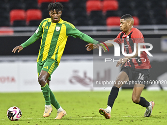 Jacinto Dala (L) of Al Wakrah SC battles for the ball with Andre Adel Bader Al-Ahmad (R) of Al Rayyan SC during the Ooredoo Qatar Stars Leag...