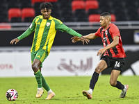 Jacinto Dala (L) of Al Wakrah SC battles for the ball with Andre Adel Bader Al-Ahmad (R) of Al Rayyan SC during the Ooredoo Qatar Stars Leag...