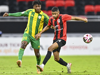 Jacinto Dala (L) of Al Wakrah SC battles for the ball with Andre Adel Bader Al-Ahmad (R) of Al Rayyan SC during the Ooredoo Qatar Stars Leag...