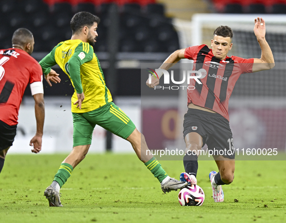 Omar Salah Alosad (L) of Al Wakrah SC battles for the ball with Andre Fonseca Amaro (R) of Al Rayyan SC during the Ooredoo Qatar Stars Leagu...