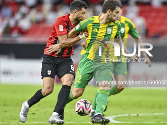 Lucas Mendes (R) of Al Wakrah SC battles for the ball with Mahmoud Hassan of Al Rayyan SC during the Ooredoo Qatar Stars League 24/25 match...