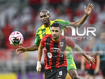 Abdelkarim Hassan of Al Wakrah SC battles for the ball with Mahmoud Hassan of Al Rayyan SC during the Ooredoo Qatar Stars League 24/25 match...