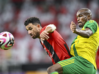 Abdelkarim Hassan (R) of Al Wakrah SC battles for the ball with Mahmoud Hassan of Al Rayyan SC during the Ooredoo Qatar Stars League 24/25 m...