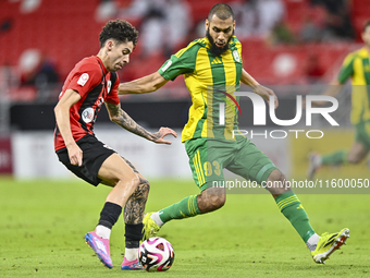 Aissa Belal Laidouni of Al Wakrah SC battles for the ball with Andre Fonseca Amaro of Al Rayyan SC during the Ooredoo Qatar Stars League 24/...