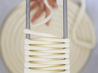 A worker processes hollow hanging noodles at a workshop in Suqian, Jiangsu province, China, on September 22, 2024. (