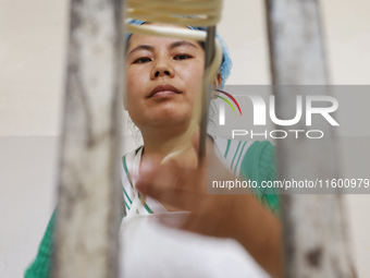 A worker processes hollow hanging noodles at a workshop in Suqian, Jiangsu province, China, on September 22, 2024. (