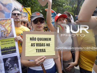 Protestors march for climate justice and against wildfires affecting the entire country in Sao Paulo, Brazil, on September 22, 2024. (