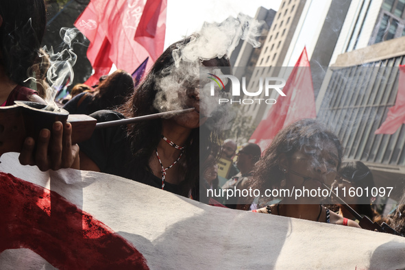 Protesters hold a demonstration against the fires and the climate situation in Brazil and for agrarian reform on Avenida Paulista, in the ce...